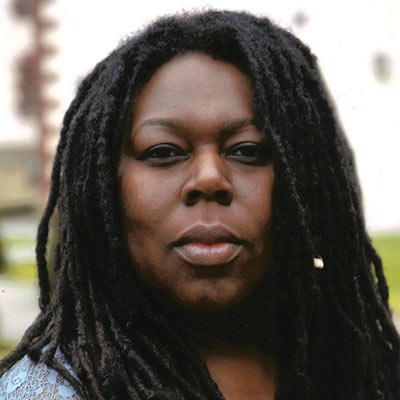 A woman with long black dreadlocks