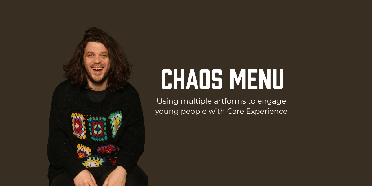 Adam Kammerling smiling in a dark jumper with bright patterned squares