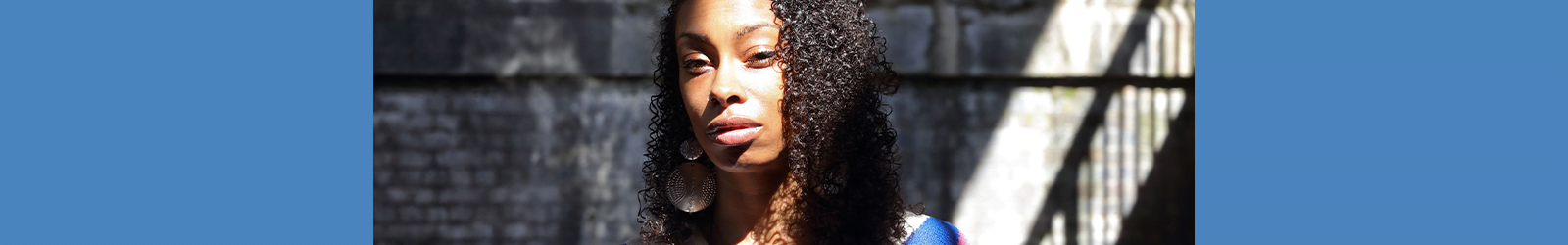 Portrait of Ioney standing with sun on her face