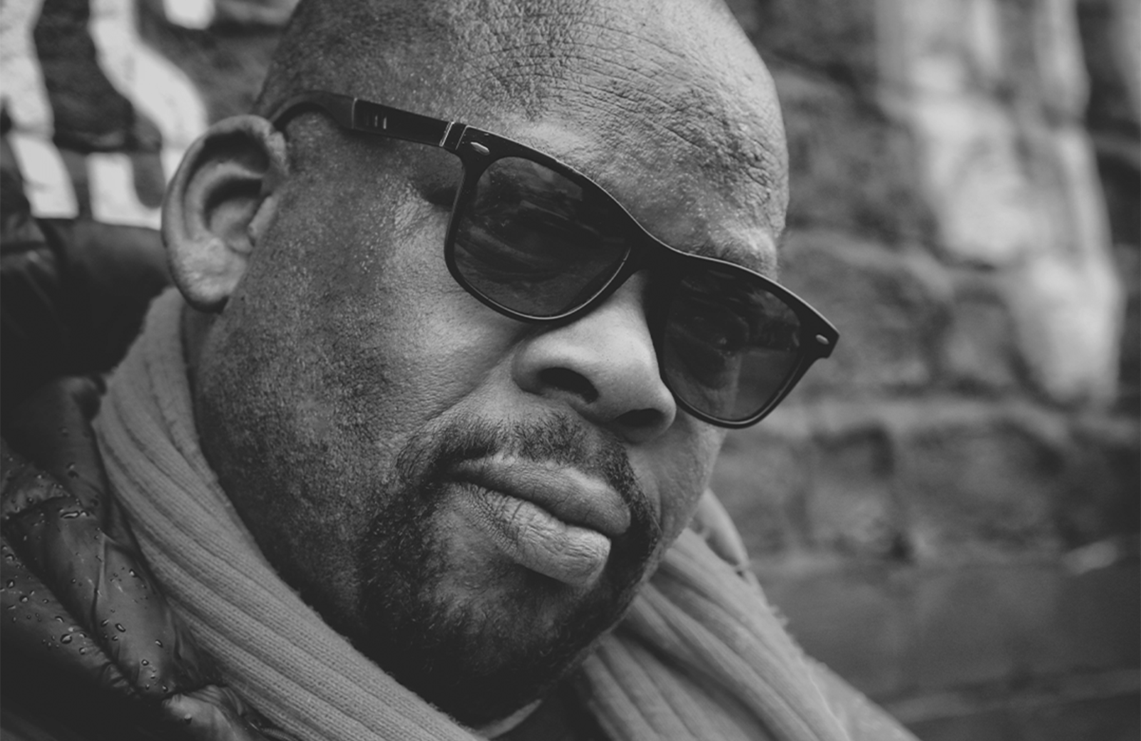 Black and white picture of Iroro looking towards camera wearing sunglasses